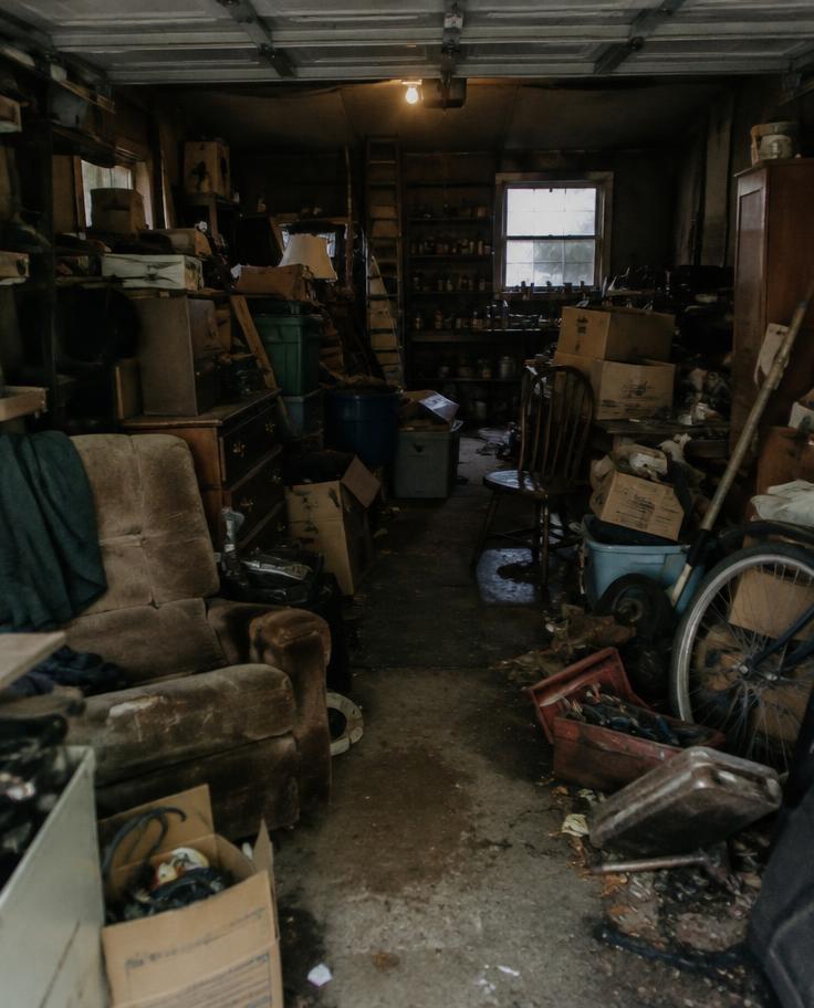 Garage packed with old furniture and boxes before a cleanout